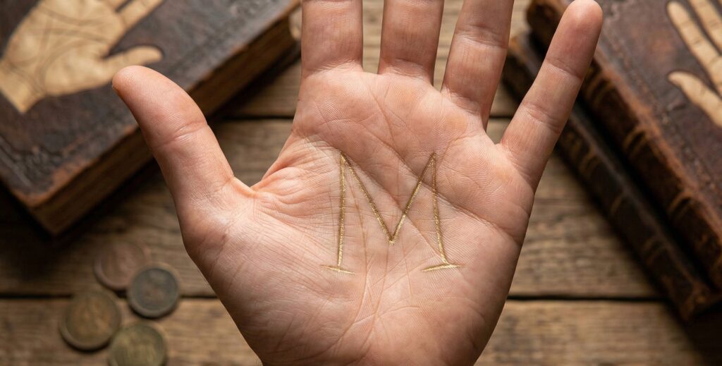 M sign on palm